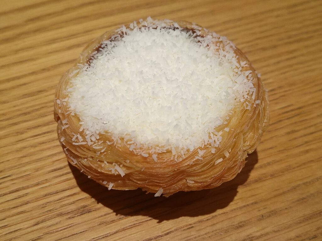An opened can of coconut milk showing thick white cream sitting above thinner liquid