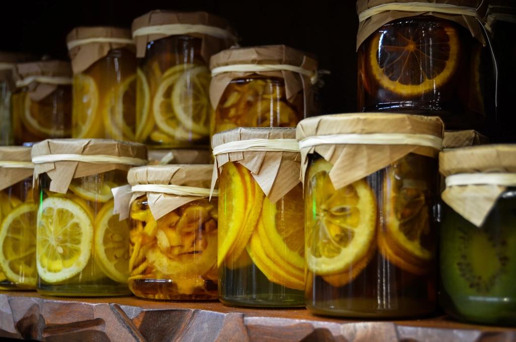 Salted lemons packed in a glass jar with their softened translucent peel showing
